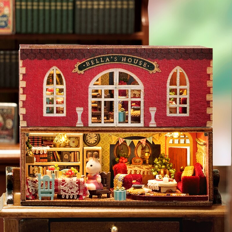 a doll house with a teddy bear sitting in it